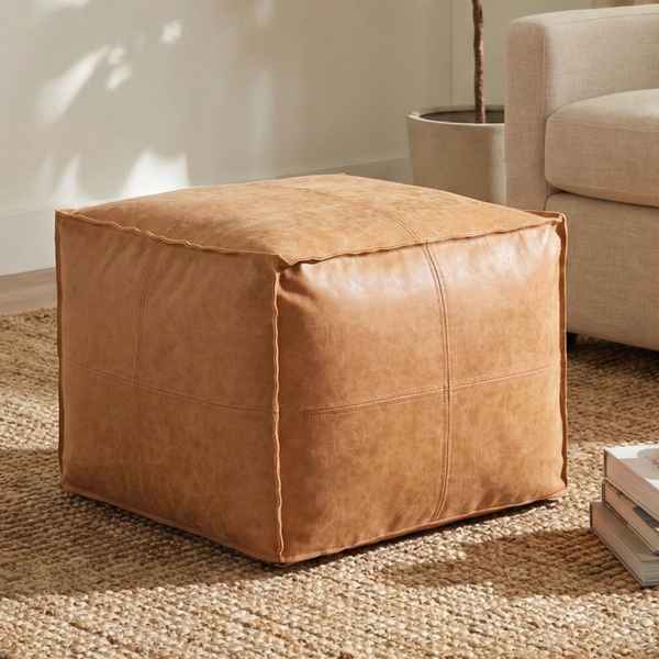 Brown leather ottoman in a living room setting
