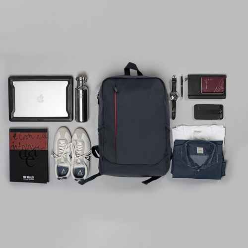 Collection of items including a backpack, shoes, and clothing on a gray background