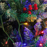Close-up of multicolor LED fairy lights on a green artificial pine tree branch, with red berries visible in the background.