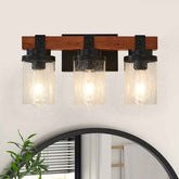Three-light wall sconce with wooden frame and glass shades on a white wall.