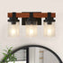 Three-light wall sconce with wooden frame and glass shades on a white wall.