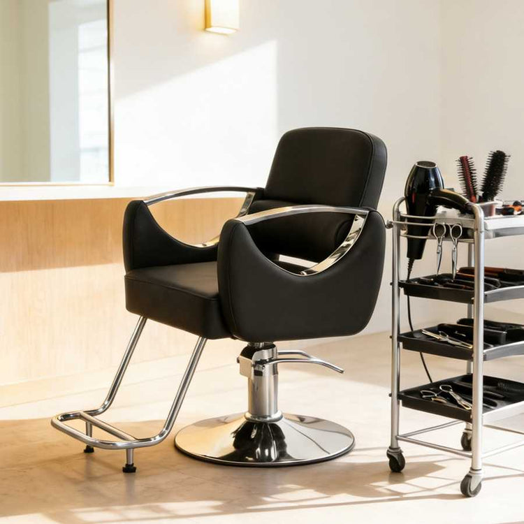 Black salon chair with a cart of tools in a well-lit room