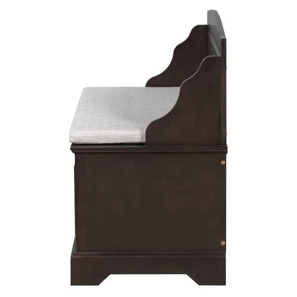 A dark brown wooden storage bench with a light gray upholstered seat cushion, shown from a side angle against a plain white background.