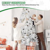 Family decorating an artificial Christmas tree with ornaments in a living room.