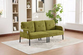 Green sofa in a room with a bookshelf and plants