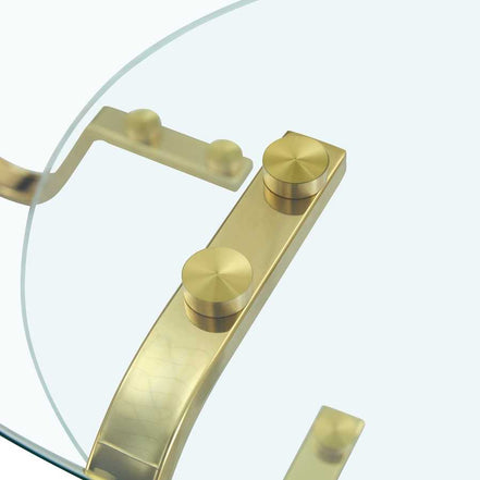 Close-up of gold metal bracket securing glass top on vintage coffee table, emphasizing quality craftsmanship.
