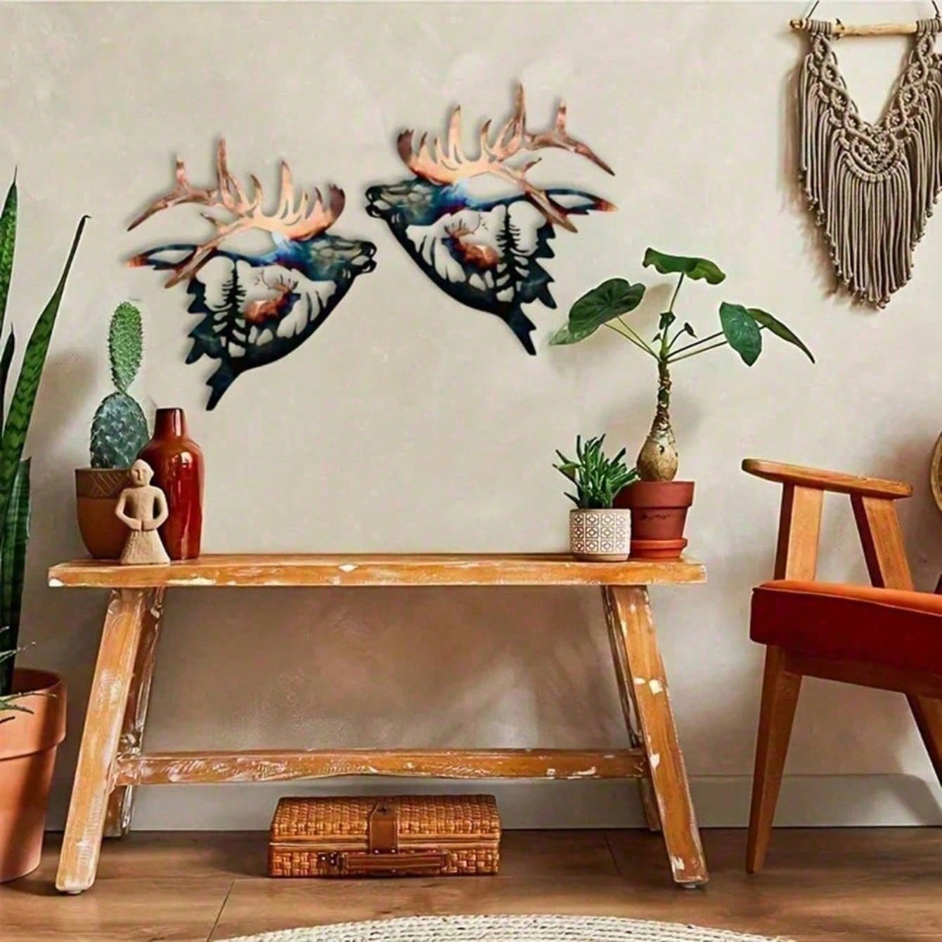 Living room with wooden console table, decorative deer heads, and plants.