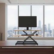 Professional office with 32 inch height adjustable desk converter supporting monitor and keyboard, perfect for standing desk setups.