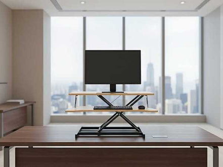 Professional office with 32 inch height adjustable desk converter supporting monitor and keyboard, perfect for standing desk setups.