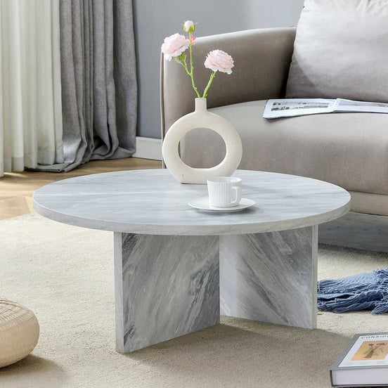 Modern MDF white round coffee table styled in a cozy living room, showcasing its Nordic design and versatile elegance.