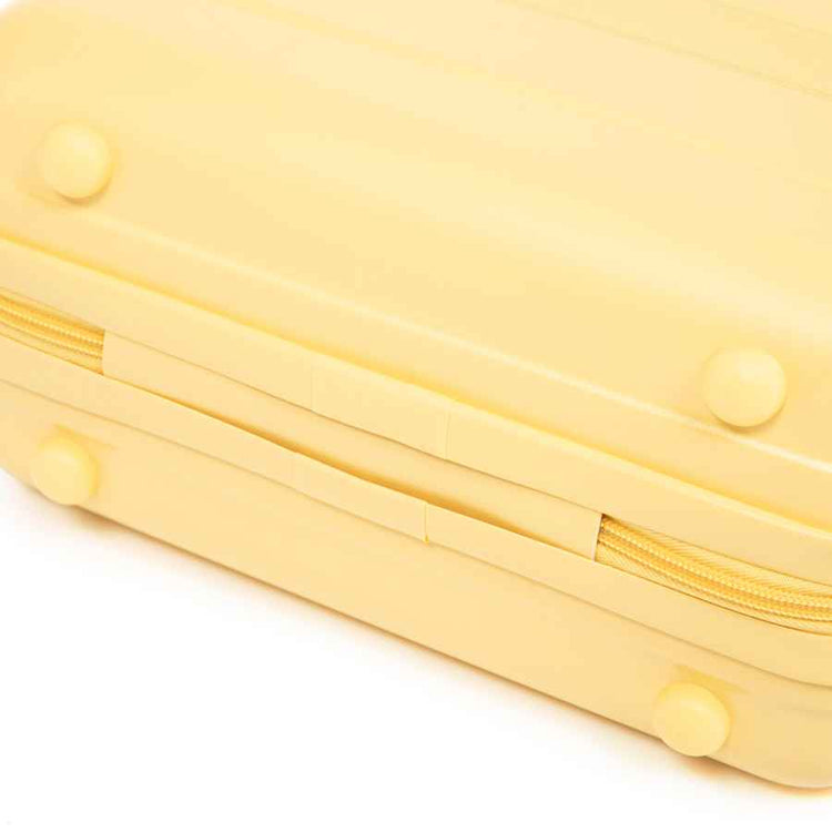 Bottom view of yellow ABS spinner luggage with rounded feet and durable exterior, showcasing its compact and lightweight design.