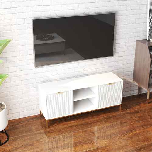 Close-up of a black flat-screen TV mounted on a white brick wall, with a white TV stand below and a wooden side table to the right