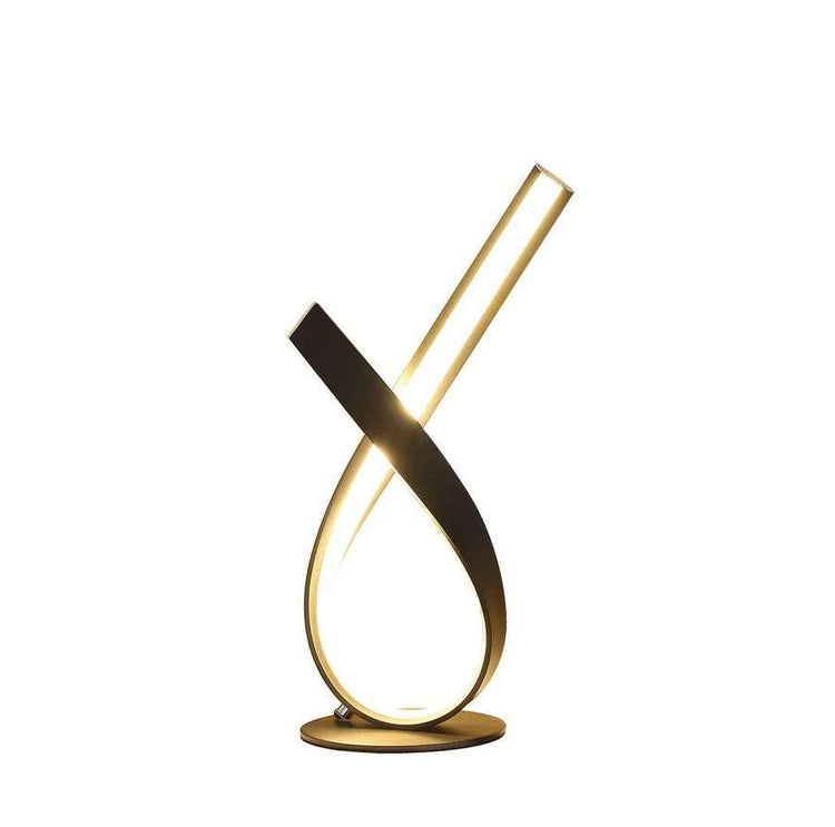 Modern gold and black table lamp on a white background