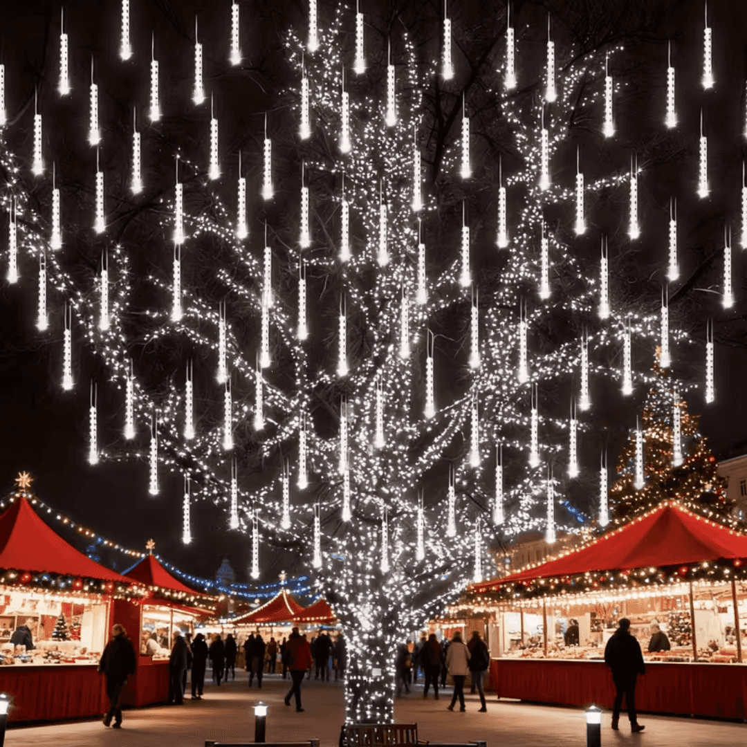 Large tree over a Christmas market lit with white meteor shower lights