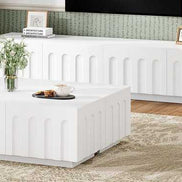 Side view of Modern TV Stand and Coffee Table Set in white, placed in a stylish living room with natural light and floral decor.
