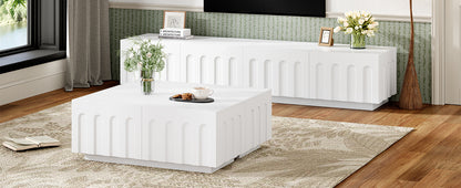 Side view of Modern TV Stand and Coffee Table Set in white, placed in a stylish living room with natural light and floral decor.