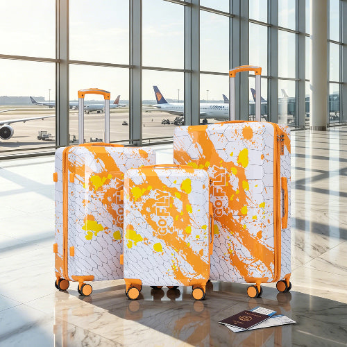 Three suitcases with orange and white pattern in an airport setting