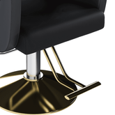 Stylish black and gold salon chair with marble floor and mirror