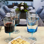 Durable BPA-free blue acrylic wine glasses from LeadingWare set of 4, shown in an elegant outdoor dining setup with red and white wine.
