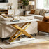 A modern console table in a styled living room, featuring a white marble top and a sculptural, interlocking gold metal base on a matching marble plinth.