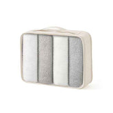 Cream-colored mesh packing cube with multiple compartments, zipper closure, and compact design for travel organization