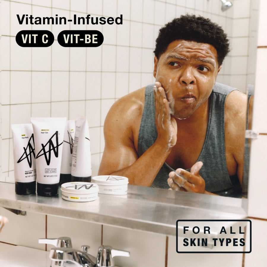 Person applying exfoliating face wash, showing skincare routine for all skin types