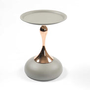 Full view of the Mermaid Tail Coffee Table with modern metal design, featuring a round grey top and gold sculptural base.