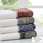 Stacked jacquard bath towels with intricate patterns in various colors