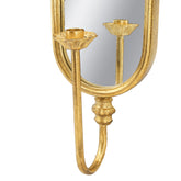 Gold wall mirror with a double candlestick sconce design, featuring an oval mirror and two decorative gold candle holders on curved arms, shown against a plain white background.