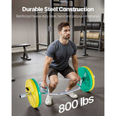 Man lifting a barbell with green and yellow weights in a gym setting, emphasizing durable steel construction.