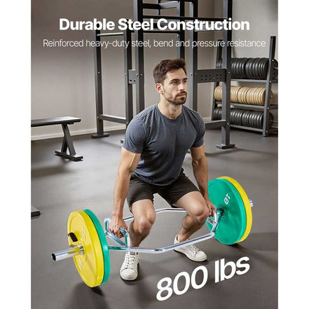 Man lifting a barbell with green and yellow weights in a gym setting, emphasizing durable steel construction.