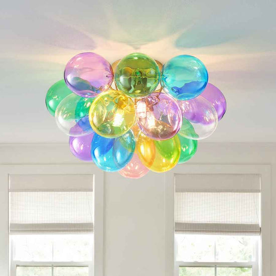 Colorful balloon-like ceiling light fixture in a room with windows.