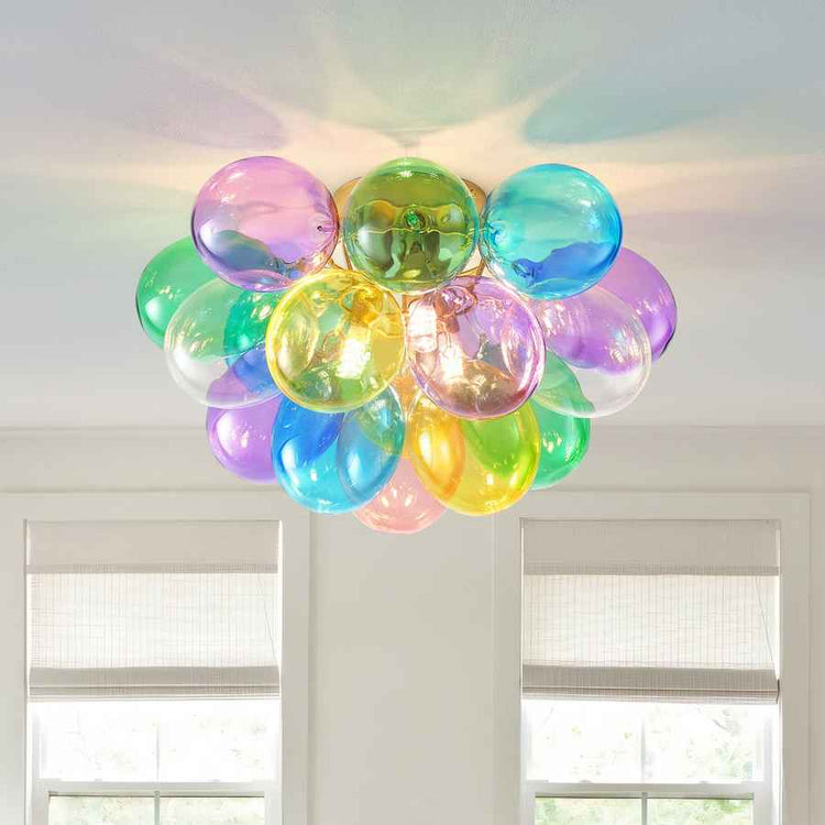 Colorful balloon-like ceiling light fixture in a room with windows.