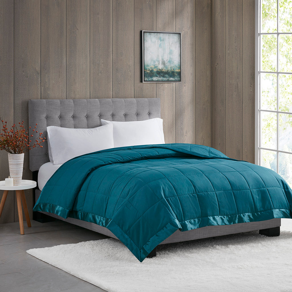 Down Alternative Blanket - Teal Twin on bed with satin trim, offering soft, hypoallergenic comfort in a modern bedroom setting.