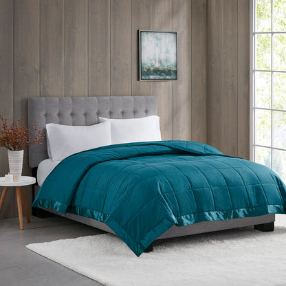 Down Alternative Blanket - Teal Twin on bed with satin trim, offering soft, hypoallergenic comfort in a modern bedroom setting.