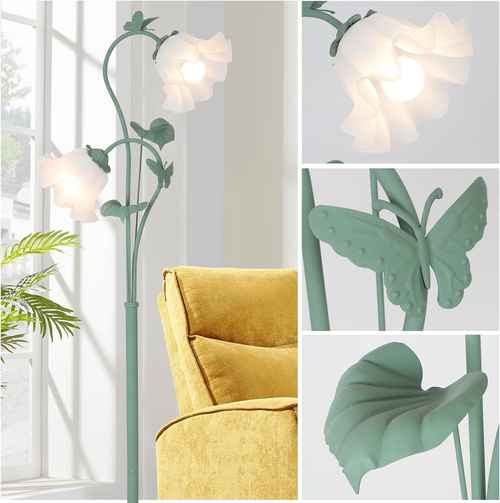 Decorative floor lamp with floral design next to a yellow armchair.