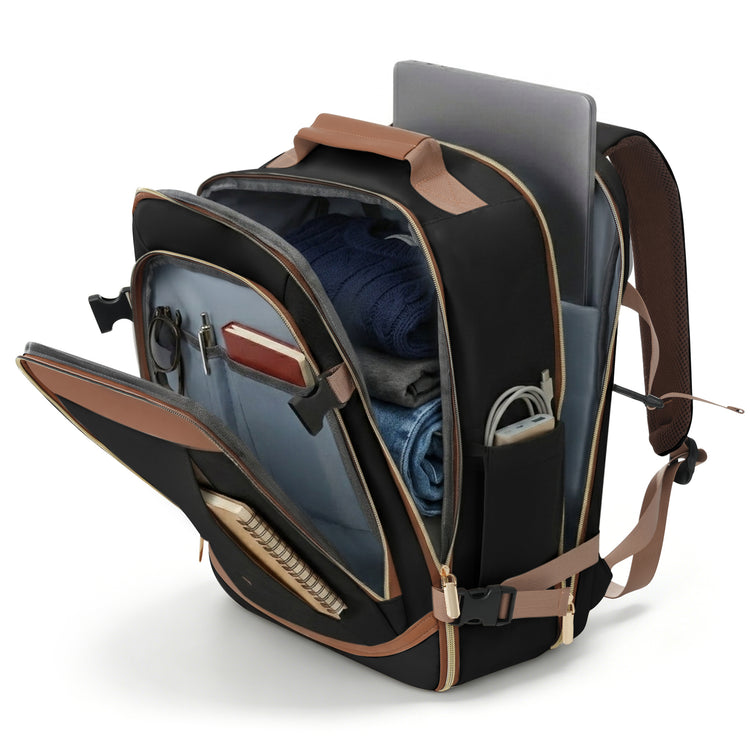 A black and brown backpack shown open, revealing its interior compartments, with a laptop, folded blue clothing, and other accessories inside, photographed on a clean white background.