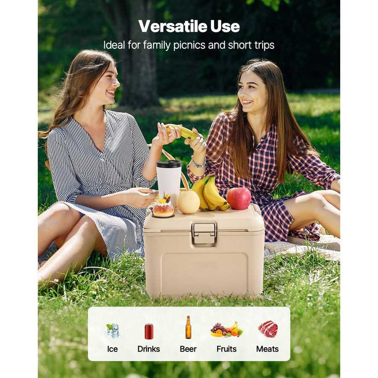 Two women having a picnic with a beige cooler box in a park.