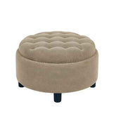 Beige round ottoman with tufted top on a white background