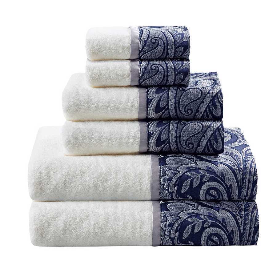 Stacked white towels with blue paisley jacquard borders