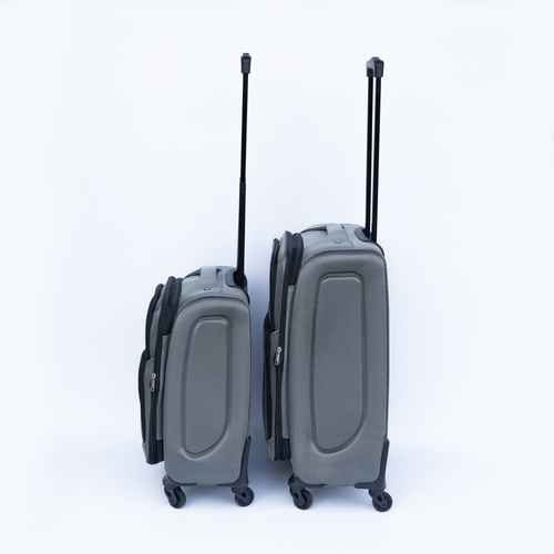 Two gray suitcases with wheels and handles on a white background