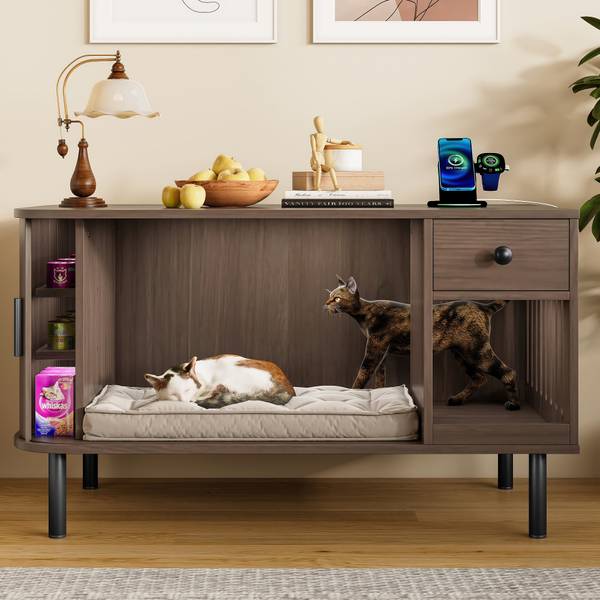 Cat litter box enclosure with cozy bedding area, storage shelves, and drawer, featuring two cats lounging inside.