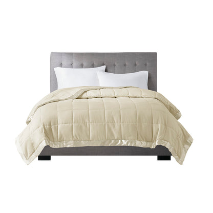 Down Alternative Blanket Twin Cream with satin trim displayed on a bed, emphasizing its soft, hypoallergenic design and elegant finish.