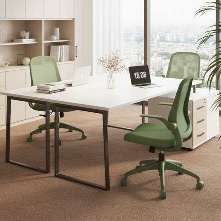 Modern office setup with green chairs and a large desk in a bright room.