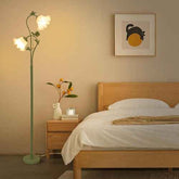 Bedroom with wooden bed, floor lamp, and wall art