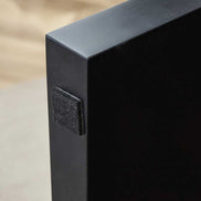 Protective felt pad on black leg of Modern Minimalist Walnut MDF Coffee Table, designed to prevent floor scratches.