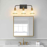 Bathroom with gold-framed mirror and wall sconce