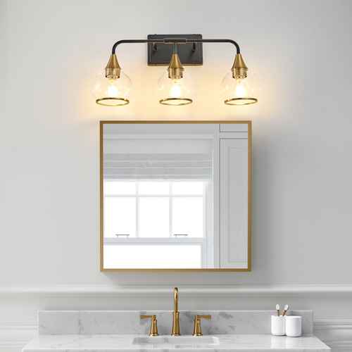 Bathroom with gold-framed mirror and wall sconce