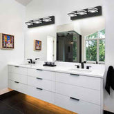 Modern bathroom vanity with a white double-sink countertop, white cabinets, black faucets, wall-mounted black three-light sconces, a large mirror, and a window view in the background.