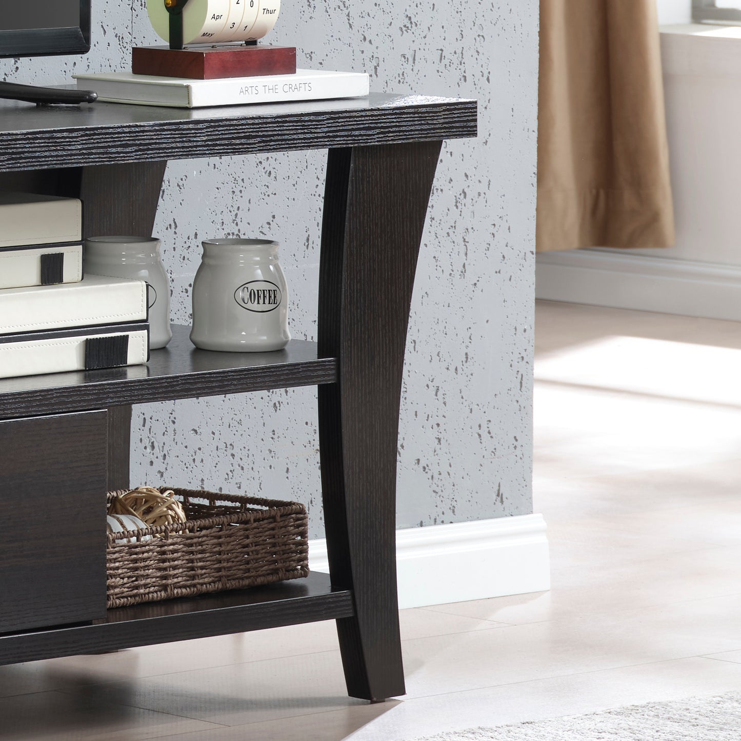 Detail of curved leg design and lower shelf on TV Stand with Storage, highlighting modern craftsmanship and dark wood texture.